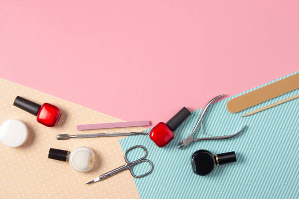 Tools for manicure on a pink and blue background. Nail files, scissors and nail polishes top view. Nail Salon, Beauty Salon - Φωτογραφία, εικόνα