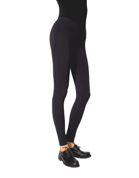 Woman wear black blank leggings mockup, isolated, clipping path. Women in clear leggins template. Cloth pants design presentation. Sport pantaloons stretch tights model wearing. Slim legs in apparel. - Foto, afbeelding