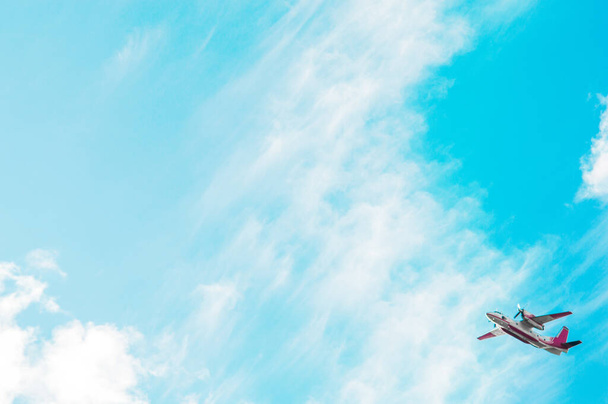 Blue sky with clouds and plane in the corner of the frame. Can be used like postcard or wallpaper in travel companies - 写真・画像