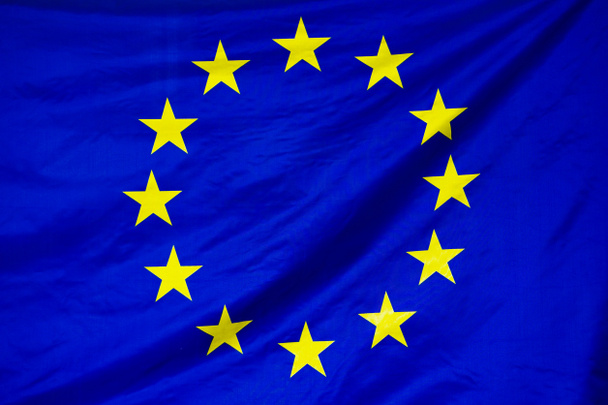 Bandiera tessuta dell'UE. Bandiera dell'UE che sventola nel vento. Bandiera Unione europea è raffigurato su un tessuto di stoffa sportiva con molte pieghe. Stendardo squadra sportiva
. - Foto, immagini