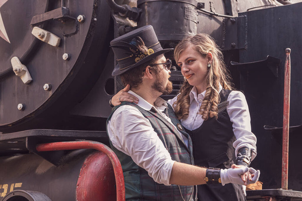 Beautiful girl with a guy, couple in love, in steampunk clothes close up - Photo, image