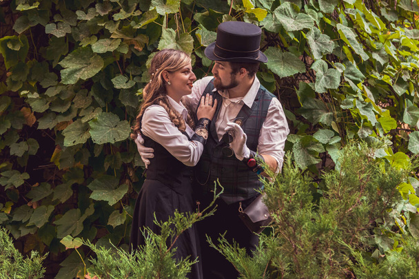Beautiful girl with a guy, couple in love, in steampunk clothes close up - Φωτογραφία, εικόνα