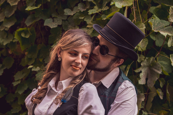 Beautiful girl with a guy, couple in love, in steampunk clothes close up - Photo, Image