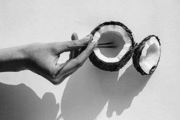 Dziewczyna trzyma słomkę na koktajl w kokosie. woda kokosowa. koktajl tropikalny - Zdjęcie, obraz