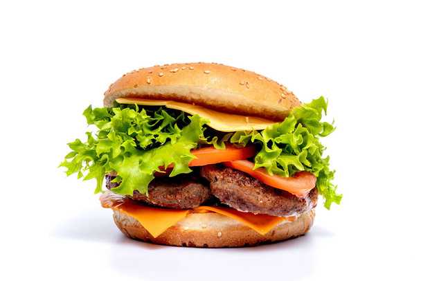 Cheeseburger or hamberger on a white background. Fast food. - Foto, afbeelding