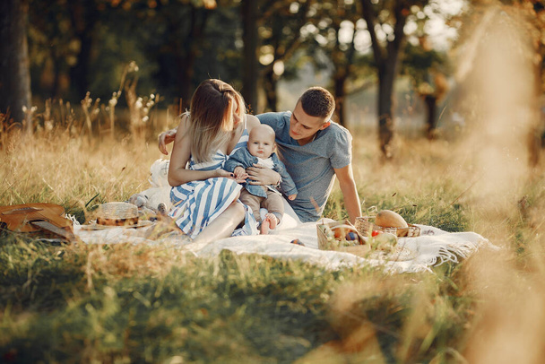 Cute family playing in a autumn field - Фото, изображение