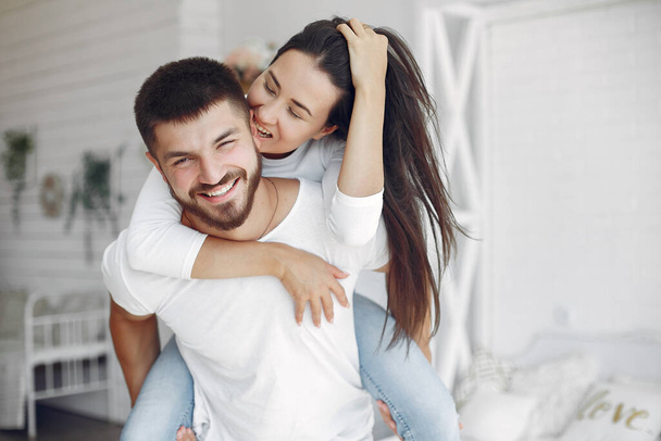 Beautiful couple spend time in a bedroom - Photo, Image