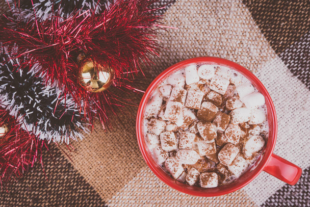 Hot chocolate and Christmas decorations on an old plaid - Photo, image