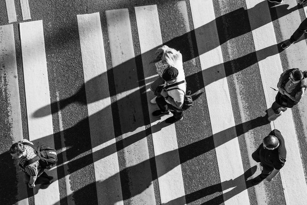 Moscow, Russia - May 18, 2019, a crowd of people cross the street at a pedestrian crossing, view from above - Photo, Image