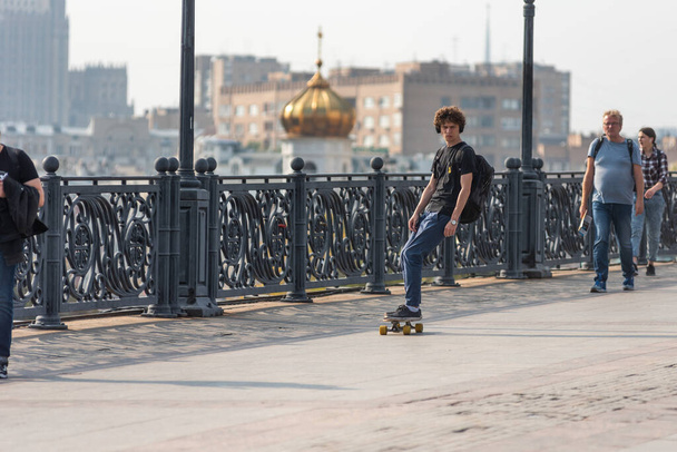 Москва, 6 сентября 2019 года - Парень на скейтборде по пешеходному мосту
 - Фото, изображение