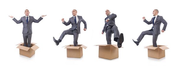 Businessman with box isolated on the white - Photo, Image