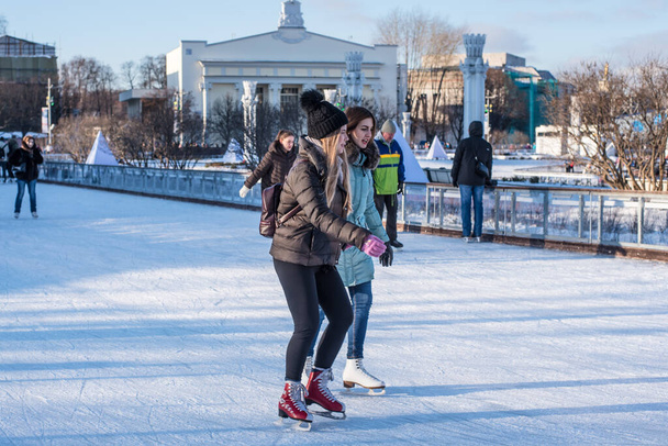 Russia, Moscow, VDNH, January 10, 2018 - Skating rink at the Exhibition of People's Economic Achievements, people skating - Zdjęcie, obraz