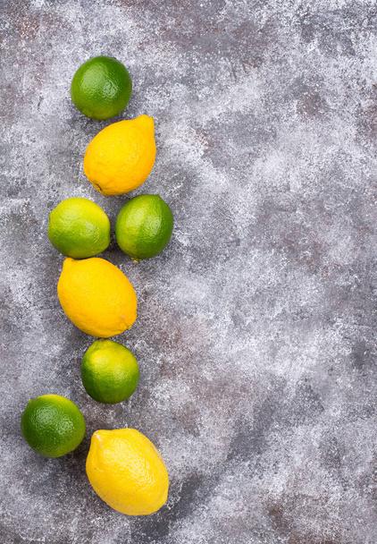 Fresh ripe limes and lemons - Fotoğraf, Görsel