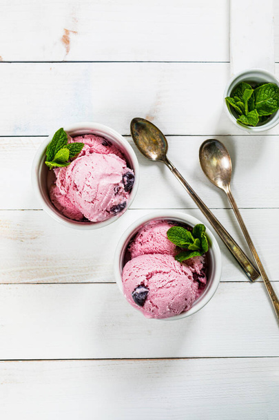 Black Cherry Vanilla Ice Cream or Cherry Frozen Yogurt on White Wooden Background. Selective focus. - Foto, afbeelding