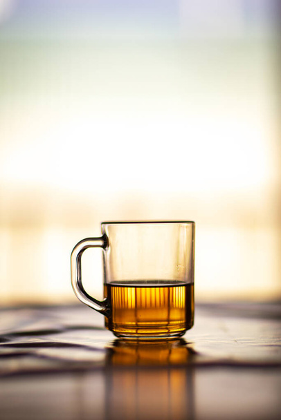 tea in a transparent mug on a warm sunny background. - Fotoğraf, Görsel