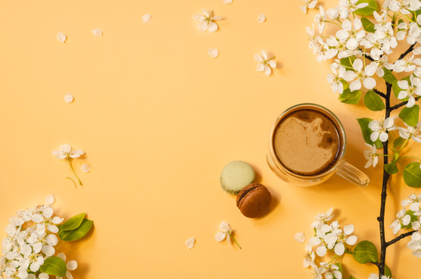 Cup coffee and bloom delicate flowers on a pastel yellow background.  - Zdjęcie, obraz
