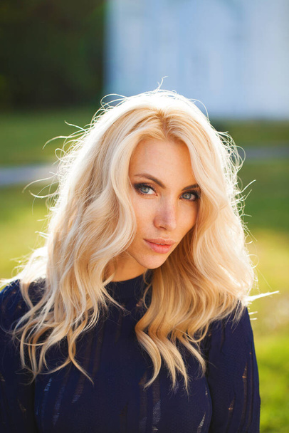 Portrait close up of young beautiful blonde woman, summer outdoors - 写真・画像