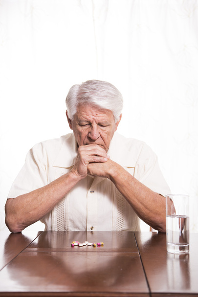 Elderly man with medication - Foto, imagen
