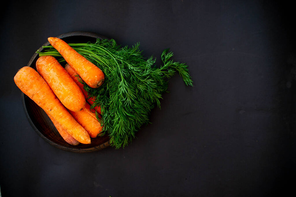 Fresh vegetables and cooking ingredients on a black background. - Zdjęcie, obraz