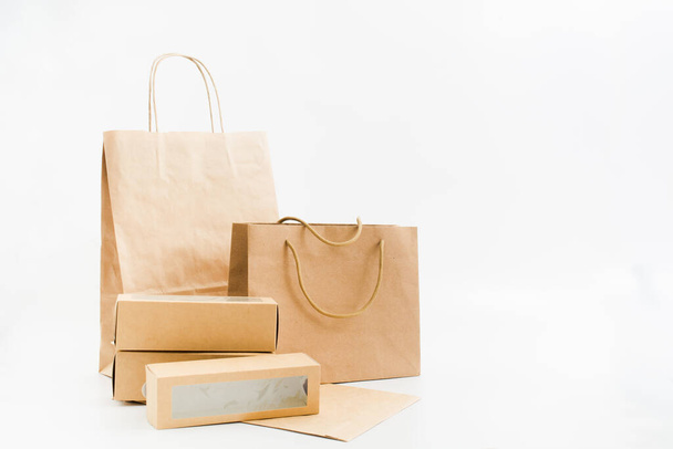 Recyclable paper bags and boxes on white background. Shopping concept - Foto, Bild