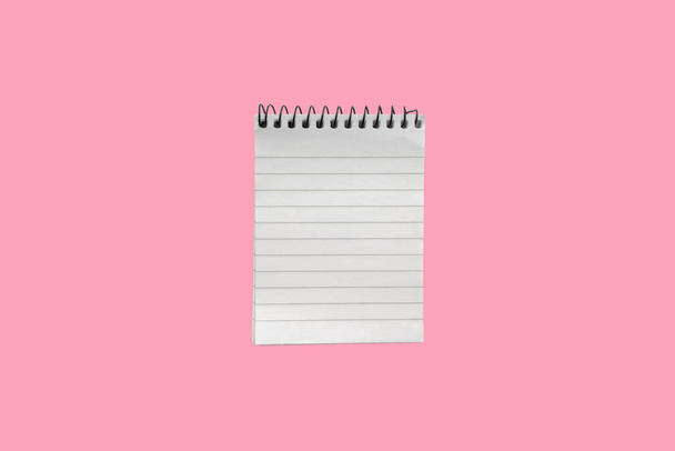 Notepad or notebook on pink background. Business and copy space concept - Photo, Image