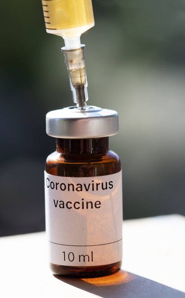 In this photo illustration vial labelled as Coronavirus vaccine and a syringe seen displayed as the world anxiously awaits for the vaccine against coronavirus.  - Photo, Image
