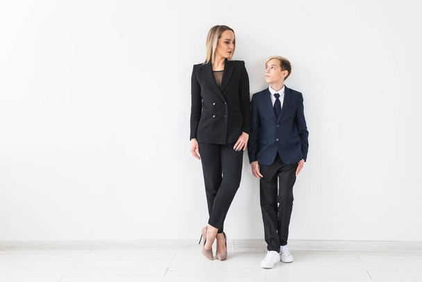 Parenting, family and single parent concept - A happy mother and teen son smiling on white background. - Photo, Image