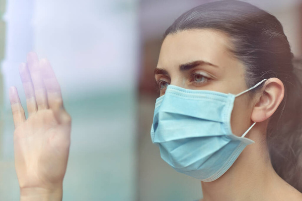 sick young woman wearing protective medical mask - Фото, изображение