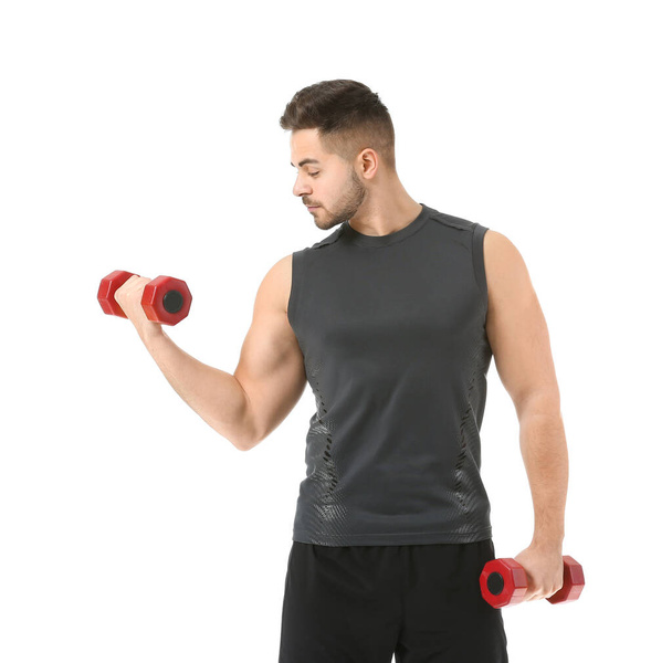 Sporty young man training with dumbbells on white background - Фото, зображення