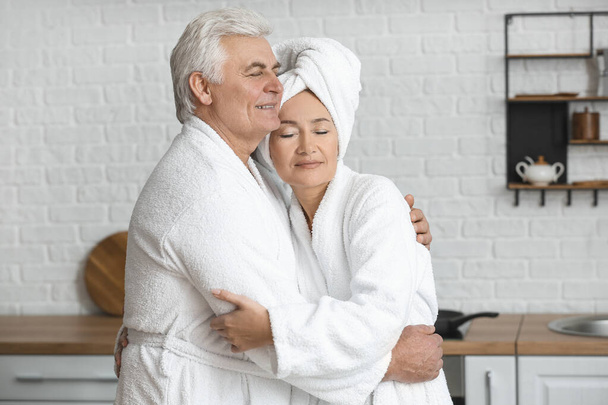 Mature couple in bathrobes at home - Photo, Image