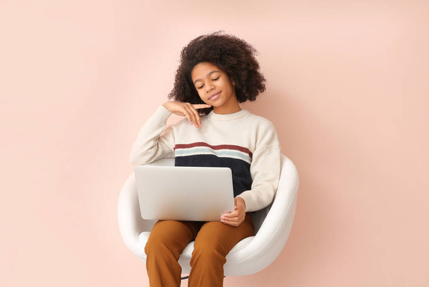 African-American teenage blogger with laptop on color background - Фото, зображення