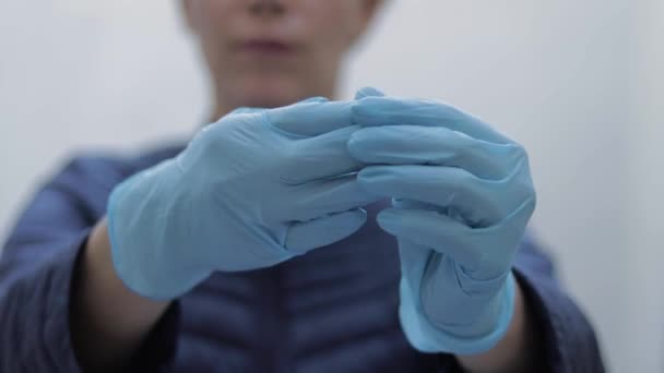 Close up of woman take on medical gloves - Felvétel, videó