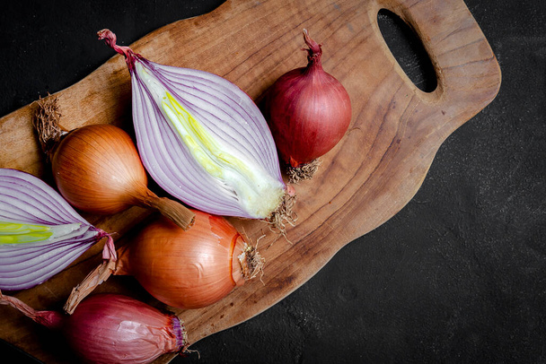 Fresh red and white onions on dark background.Vegan food.Food Ingredient - Zdjęcie, obraz