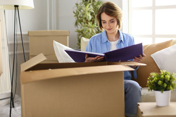 Young woman moving out and packing cardboard box - Photo, image