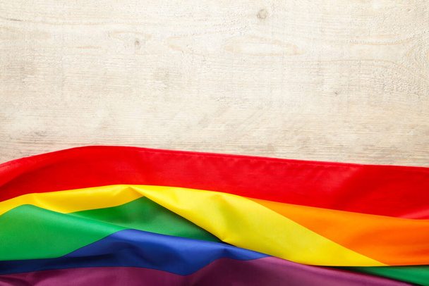 Rainbow LGBT flag on light background, top view - Foto, Imagen