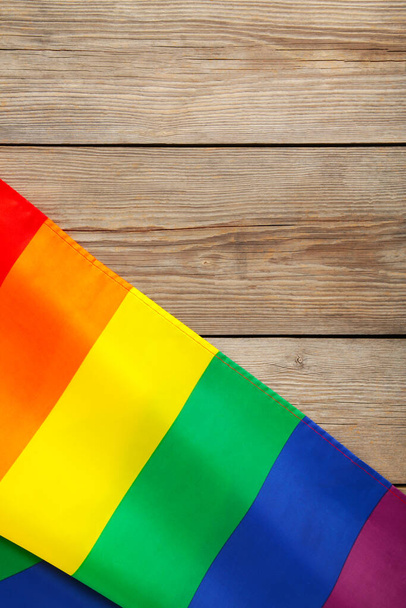 Rainbow LGBT flag on grey wooden background, top view - Foto, Imagen