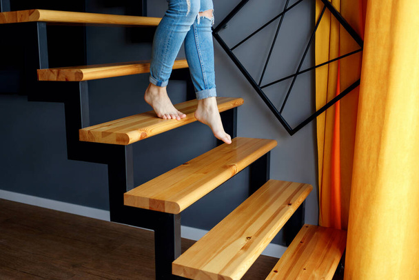 Woman in blue jeans go down in stairs. - Photo, Image