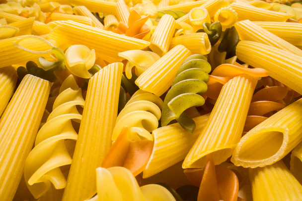Variety of types and shapes of dry Italian pasta close-up. Food and traditional cuisine. - Photo, Image