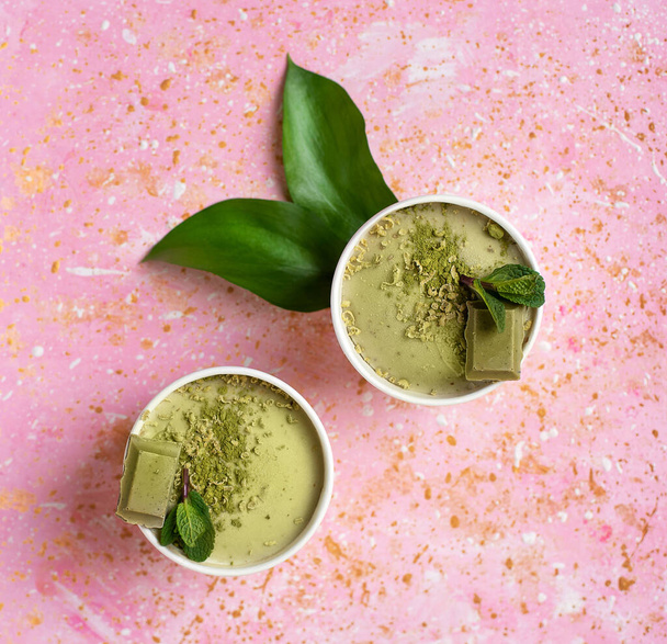 Ice cream with green tea on a pink background. Mint leaves. Food photography. - Valokuva, kuva
