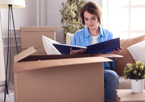 Young woman moving out and packing cardboard box - Photo, Image