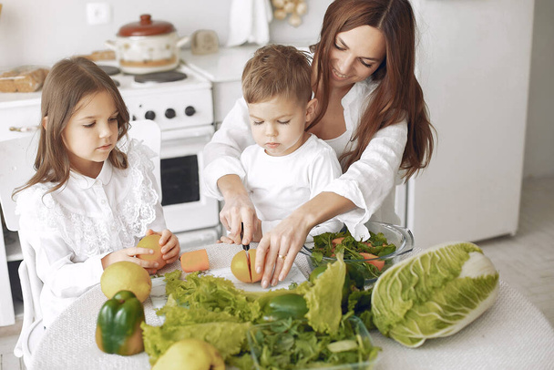 Family prepare the salad in a kitchen - Photo, Image