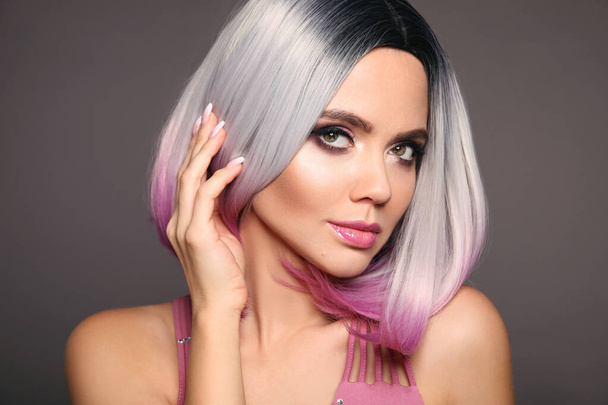 Beauty Portrait of woman with Ombre bob short hairstyle. Beautiful coloring  hair. Trendy puprle haircut. Blond model with short shiny haircuts isolated on grey Background. Makeup. Manicured nails. - Foto, imagen