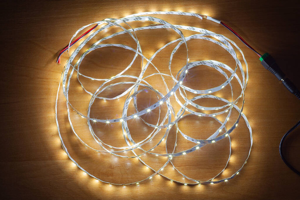 LED strip on a wooden table, close-up - Photo, Image