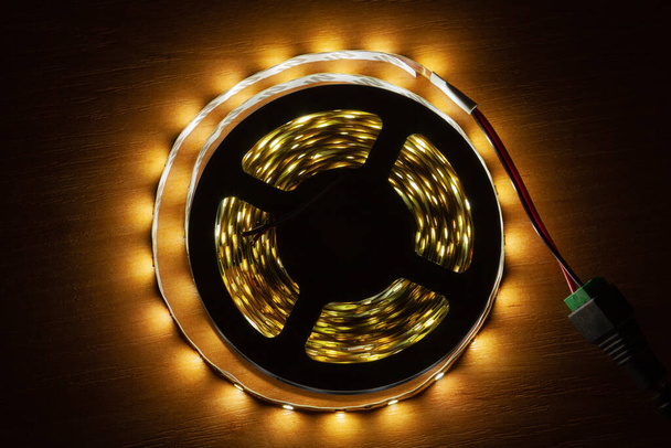 LED strip on a wooden table, close-up - Photo, Image