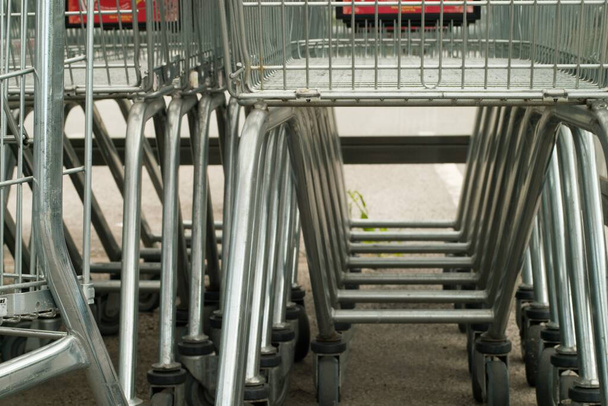 A closeup shot of the shopping trolley carts near the supermarket - Photo, Image