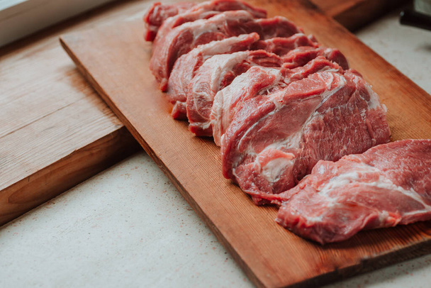Pork chops on a cutting board. Selective focus - Foto, immagini