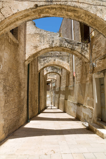 ancient narrow italian street with stone archs in Monopoli, italy - 写真・画像