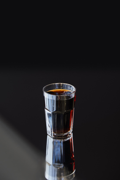 fresh soda in glass with reflection in sunlight on black background - Valokuva, kuva