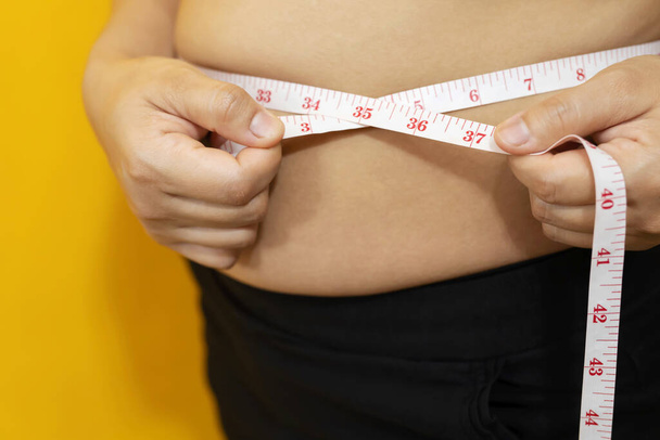 Obese vrouw, ze proberen om gewicht te verliezen, zoals dieet en lichaamsbeweging elke dag. - Foto, afbeelding