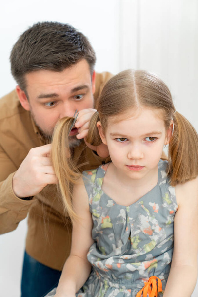 dad cuts hair at home child during quarantine. - Photo, image